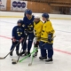 Blind Icehockey, fyra personer står på en hockeyrink i en ishall